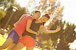 Two young women taking self portrait in park