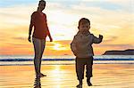 Mother and toddler son playing on beach, San Diego, California, USA