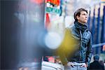 Young male tourist exploring streets, New York City, USA