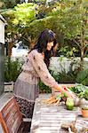 Young woman with vegetables on table