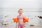 Young girl with armbands on the beach