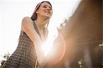 Teenage girl leaning on railings in park