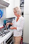 Senior woman cooking at kitchen counter