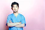 Young Asian Trainee Doctor wearing Scrubs