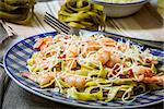 pasta tagliatelle with prawn and bacon on the wooden table