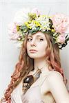 calm pretty girl with snail and flower crown on head on white background