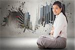 Businesswoman sitting cross legged with arms crossed against splash showing cityscape