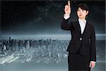 Focused businesswoman pointing against balcony overlooking city