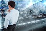 Thoughtful businessman with hand on chin against math equation background