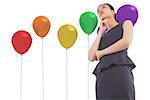 Thinking asian businesswoman against colourful balloons