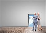 Serious businessman standing back to back with a woman  against door opening showing blue sky