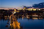 Charles Bridge over the River Vltava and Little Quarter illuminated at dusk, UNESCO World Heritage Site, Prague, Czech Republic, Europe