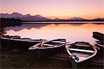 Rowing boats on Hopfensee Lake at sunset, near Fussen, Allgau, Allgau Alps, Bavaria, Germany, Europe