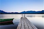 Rowing boat on Hopfensee Lake at sunset, near Fussen, Allgau, Allgau Alps, Bavaria, Germany, Europe