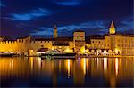 View of city across river, lit up at dusk, Trogir, UNESCO World Heritage Site, Dalmatian Coast, Croatia, Europe