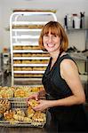 Female baker checking waffles into cooling tray