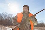 Mid adult man holding shotgun in Petersburg State Game Area, Michigan, USA