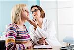 Mature Doctor with Patient in Doctor's Office