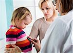 Doctor with Stethoscope in Exam Room with Baby Girl and Mother