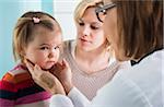 Doctor Examining Baby Girl with Mother