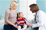 Doctor with Baby Girl and Mother in Doctor's Office