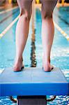 Woman at swimming pool, close-up of legs