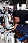 Cropped image of man preparing coffee at mobile coffee shop