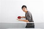 Handsome Asian man playing ping pong