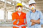 Portrait of confident male construction workers in protective workwear at site