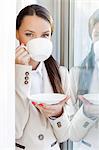 Portrait of businesswoman drinking coffee in office