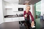Happy senior woman cleaning kitchen counter