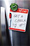 Close-up of Front of Stainless Steel Refridgerator with Magnetized To Do List