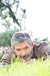 Mature man laying on the grass