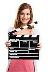 Beautiful blonde woman holding  a clapboard, isolated over white background