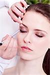 at the cosmetic studio eyeliner on eyes doing make up woman portrait closeup