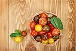 Colorful cherry tomatoes on wooden table background with copy space