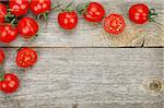 Cherry tomatoes on wooden table background with copy space