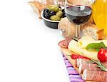 Red wine with cheese, prosciutto, bread, vegetables and spices. Isolated on white background with copy space