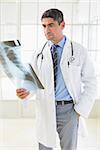 Serious male doctor examining xray in the hospital