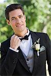 Portrait of nervous bridegroom in garden