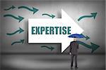 The word expertise and businessman holding umbrella against arrows pointing