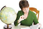 Pretty middle-aged woman studying in the library.  White background.