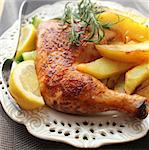 roasted chicken leg with  potato and lemon