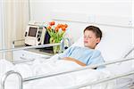 Sick little boy sleeping in hospital ward