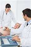 Excited pregnant woman having a sonogram scan at the hospital