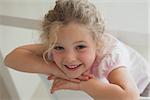 Close-up portrait of a cute smiling young girl in the house