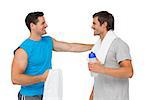 Happy fit young men with water bottle and towels standing over white background