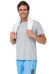 Portrait of a fit young man with towel standing over white background
