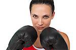 Close-up portrait of a determined female boxer focused on her training over white background