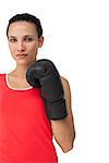 Portrait of a determined female boxer focused on her training over white background